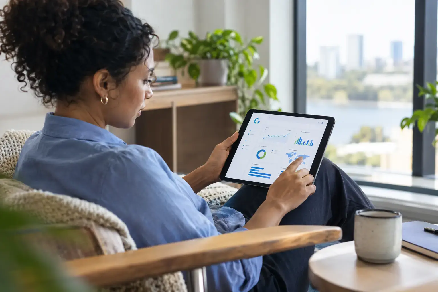 Analyst reviewing an AI visibility tracking dashboard on a tablet at home